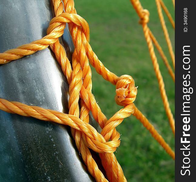 Knotted orange rope and netting from a soccer goalpost.