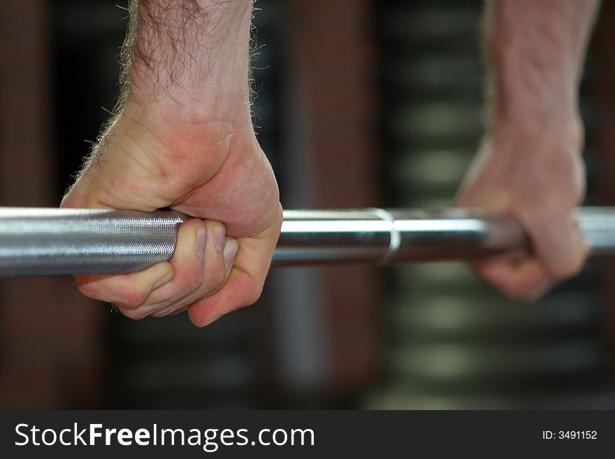 Two hands held close a Yoke / Exercises in the gym. Two hands held close a Yoke / Exercises in the gym