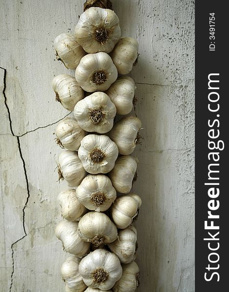 Garlic hanging on an old village wall