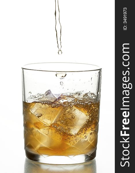 Glass with whiskey and ice on the white background
