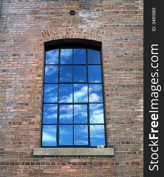 Reflections of the sky and clouds in a window