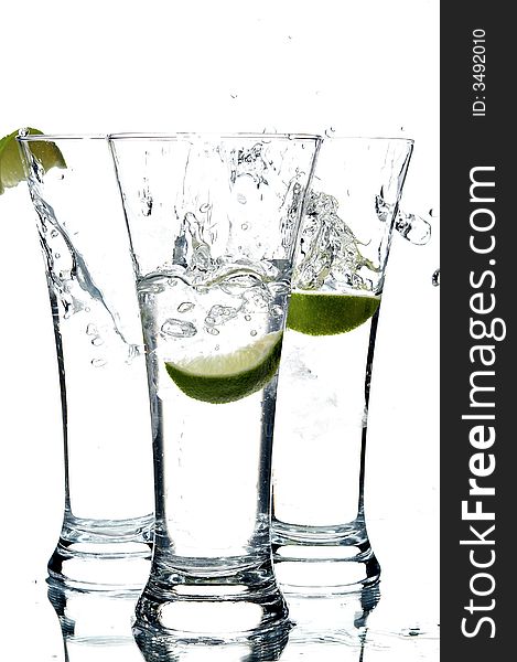 Glass with water and lemon on the white background