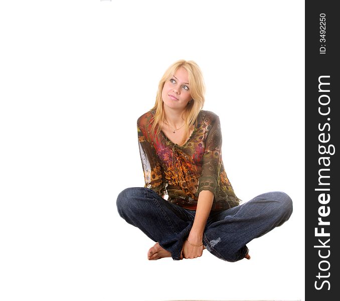 Beautiful blond girl sitting on the floor