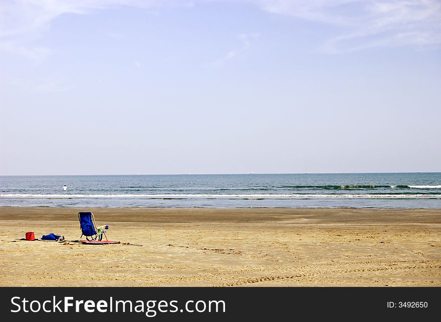 An empty beach chair on an empty beach. An empty beach chair on an empty beach.