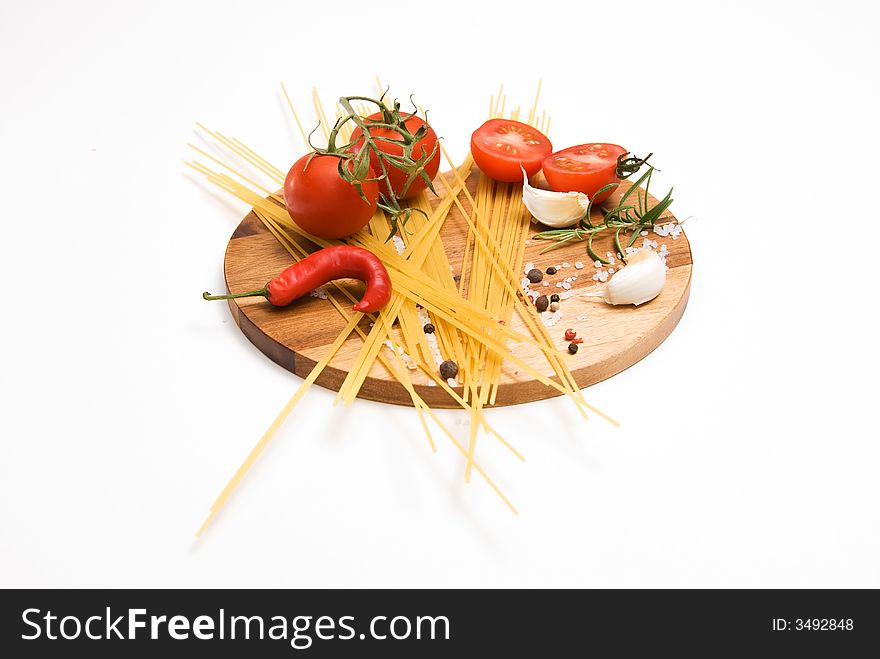 Pastaingredients on a wooden plate with spices. Pastaingredients on a wooden plate with spices