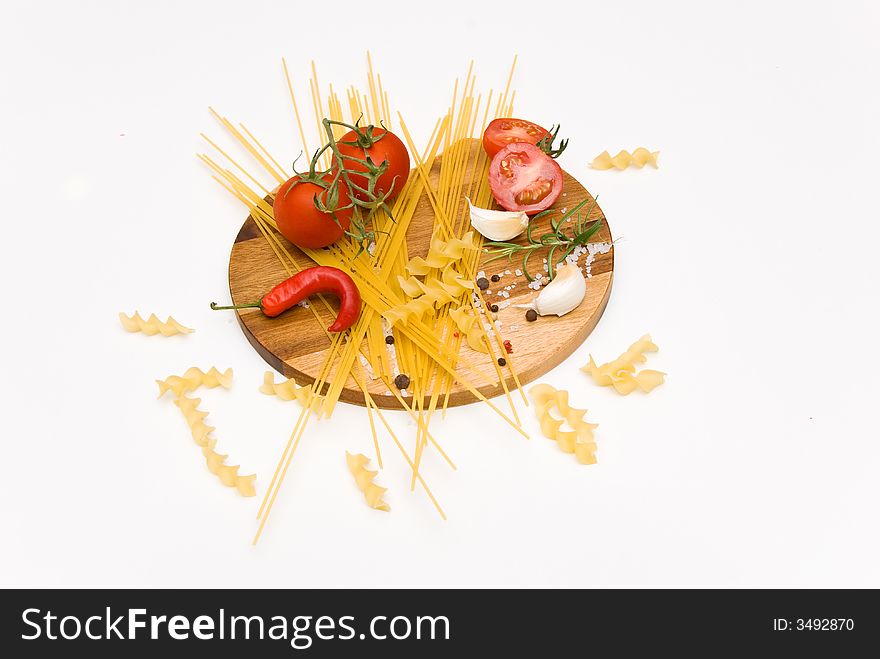 Pastaingredients on a wooden plate with spices. Pastaingredients on a wooden plate with spices