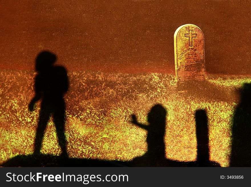 Silhouettes in a cemetery, with tombstone in background. Silhouettes in a cemetery, with tombstone in background