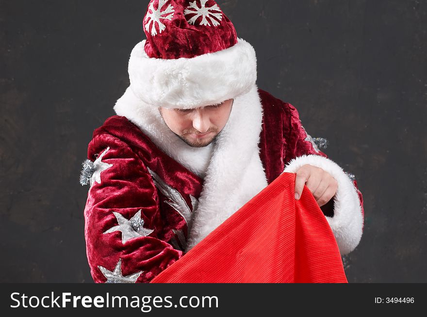 Santa Claus carrying a red bag. Santa Claus carrying a red bag