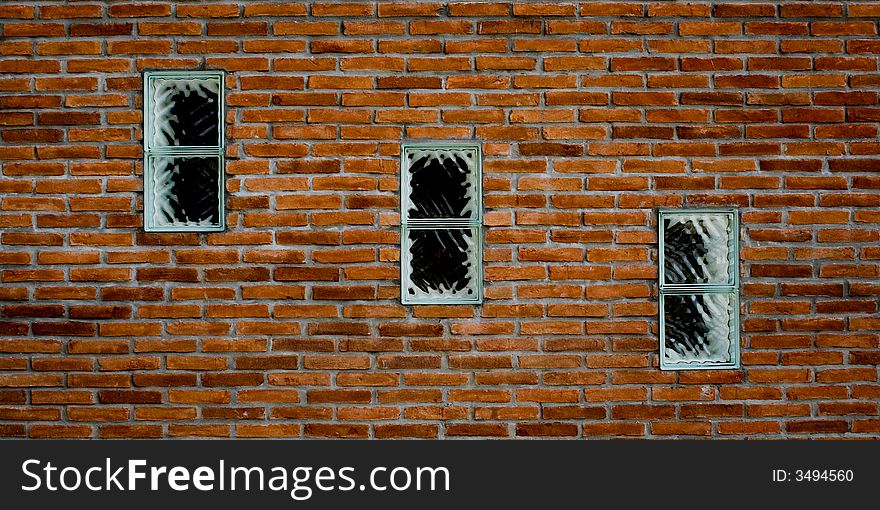 3 windows in a brick wall in diagonal