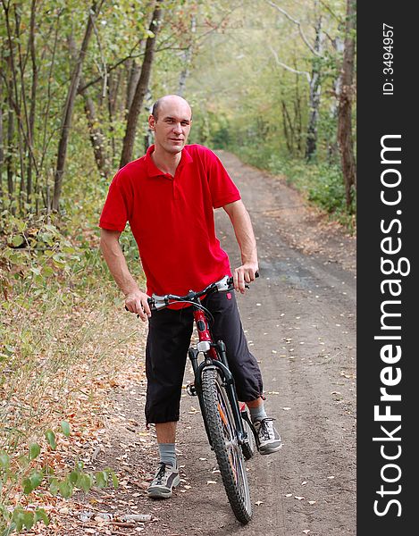 Man biking in autumn forest