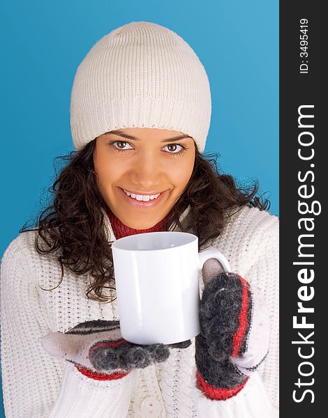 Winter girl drinking tea isolated on blue background