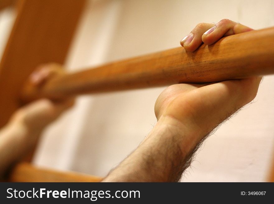 Hands of a man who grasps the shaft of a wall bars. Hands of a man who grasps the shaft of a wall bars