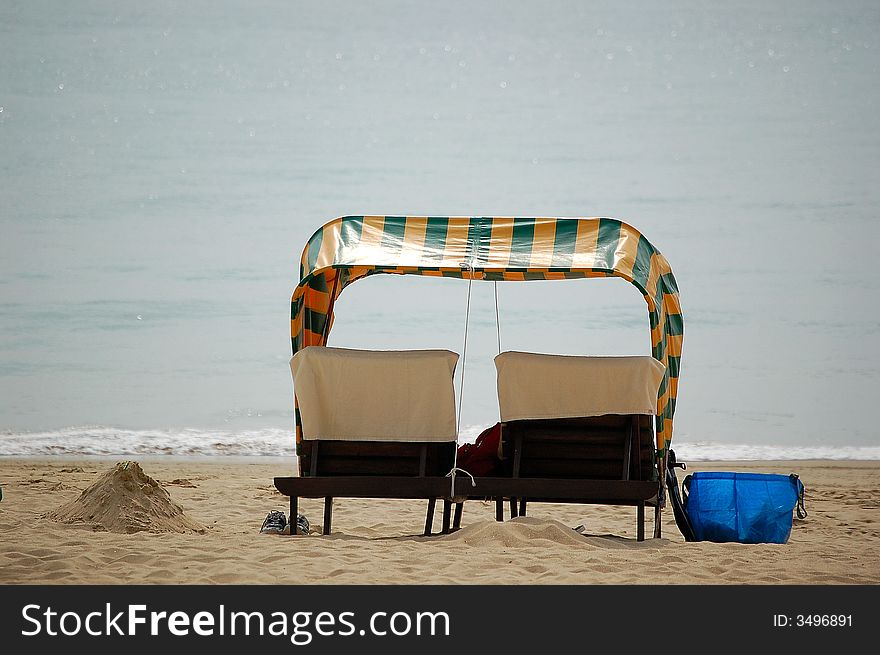Two seats with umbrella on the beach. Two seats with umbrella on the beach.