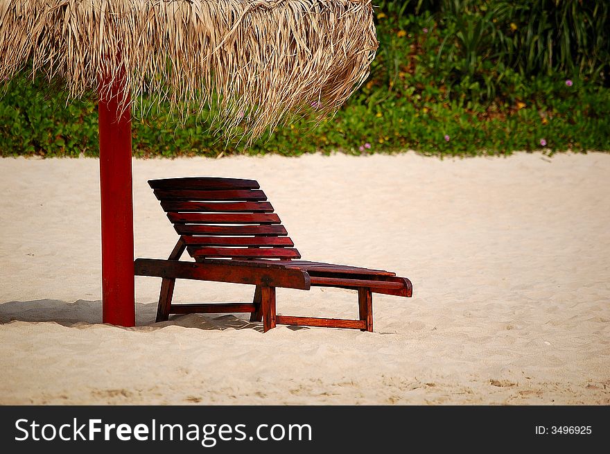 A umbrella and a seat on the beach, shot at Yalong bay, Sanya, Hainan island, China. A umbrella and a seat on the beach, shot at Yalong bay, Sanya, Hainan island, China.