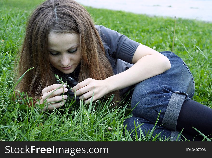 A girl looking at grass. A girl looking at grass