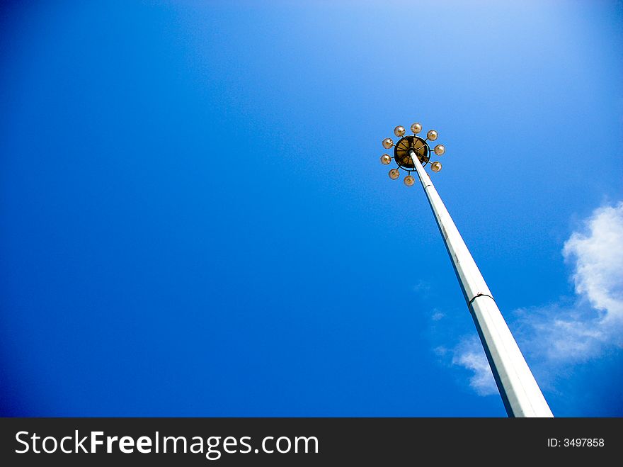 A searchlight under the blue sky seems like it is higher as the sky. A searchlight under the blue sky seems like it is higher as the sky