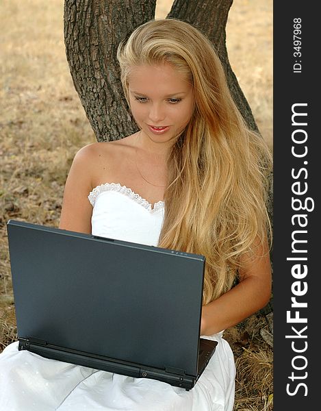 Beautiful girl with a laptop summer