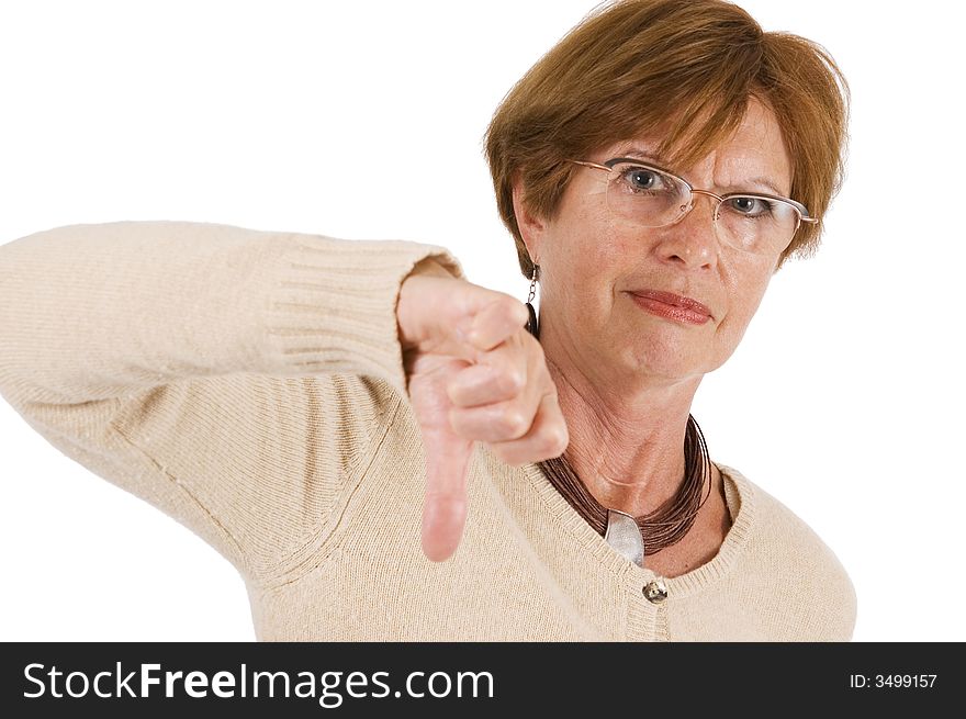 Mature woman holds the thumbs downward with stretched hand; front view. Mature woman holds the thumbs downward with stretched hand; front view