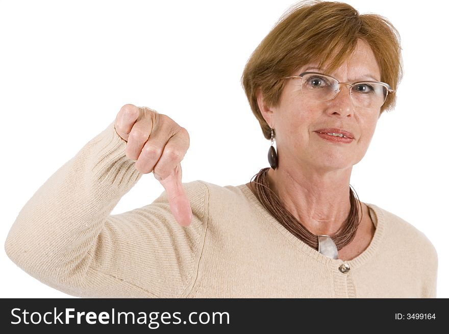Mature woman holds the thumbs downward with stretched hand; front view. Mature woman holds the thumbs downward with stretched hand; front view