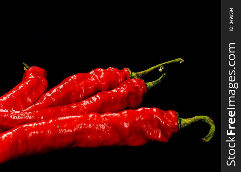 Red Hot chili peppers on black background