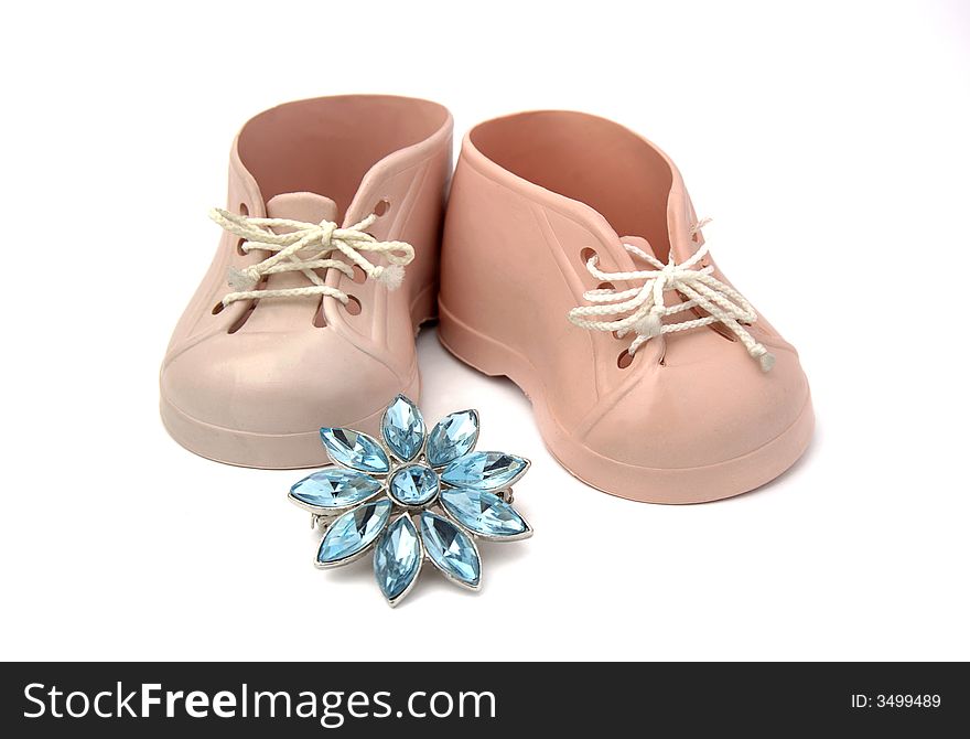 Baby shoes in pink plastic with adornment of brilliant