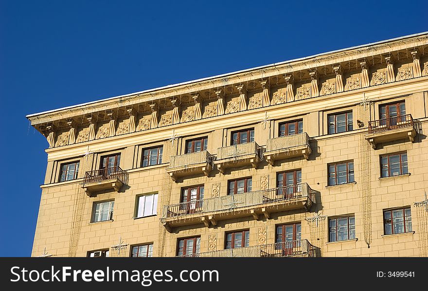 Top of the building. Roofs, balcony, windows and sky