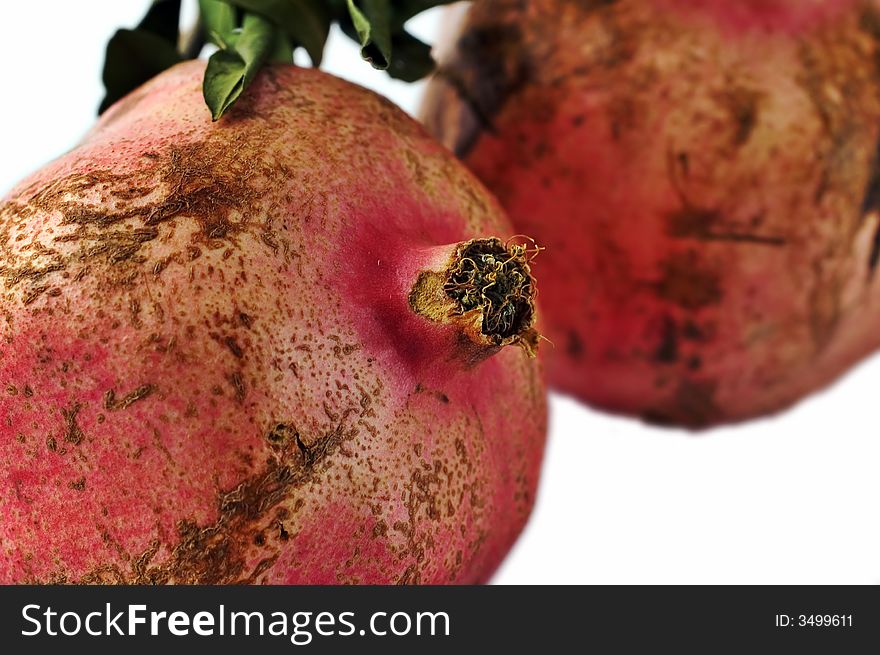 Two pomegranates isolated on white with shallow depth of field