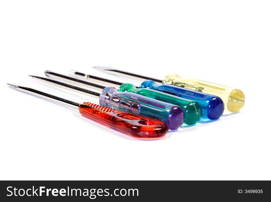 A set of turnscrews with colorful transparent plastic gripes and different points for small works. Shallow depth of field. Focus on gripes. Isolated over white