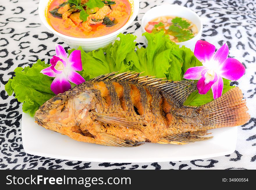 Tilapia fish fried in the dish and sauce