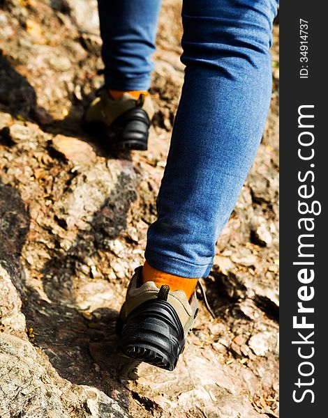 Woman hiking on a path in the mountain. Woman hiking on a path in the mountain