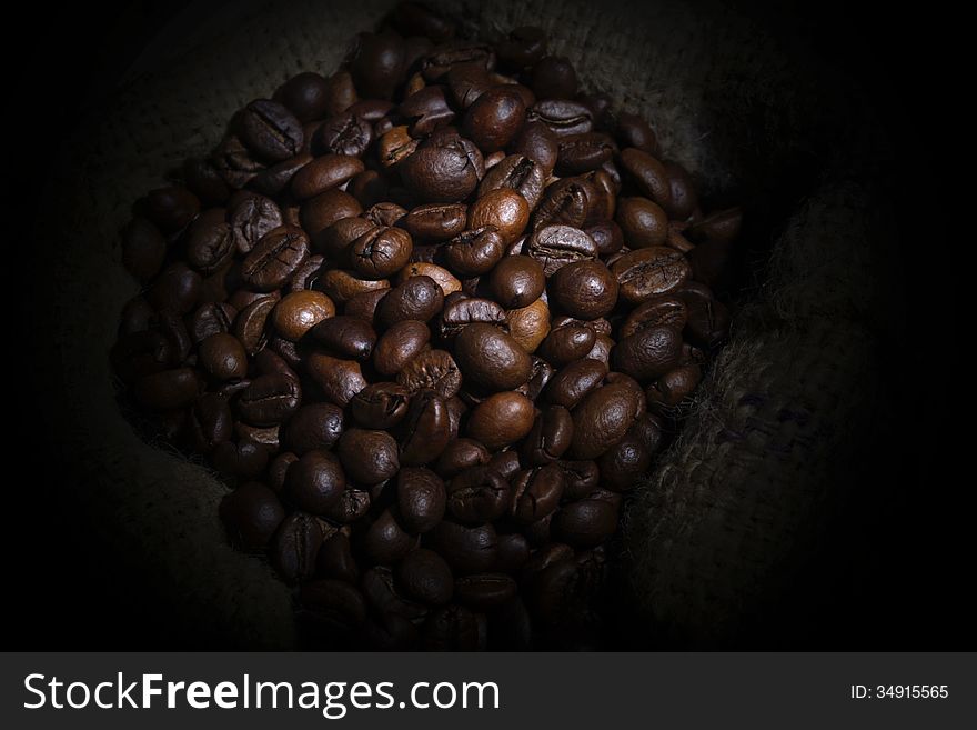 Spill Robusta Coffee Beans on Goni Sack