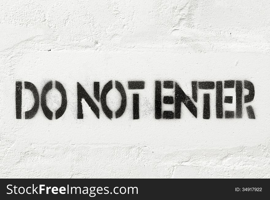 Do not enter stencil print on the white brick wall