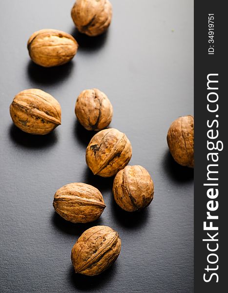 Entire walnuts on white glossy background