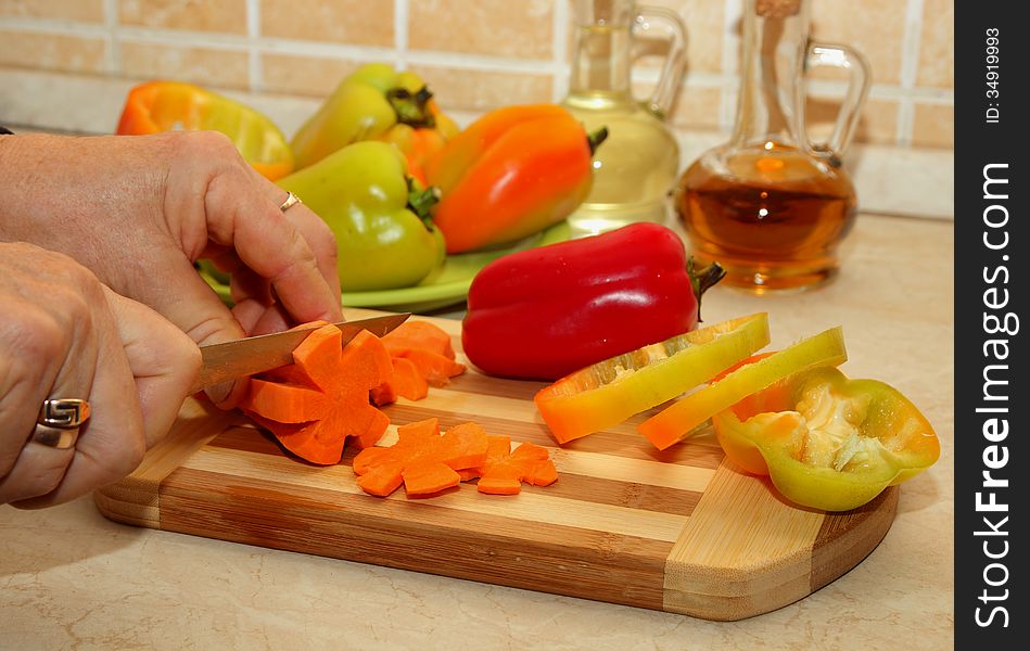 Cutting carrots on a cutting board