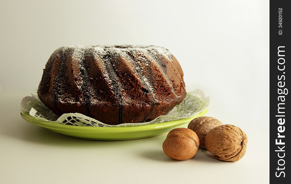 Chocolate Cake On A Plate And Walnuts