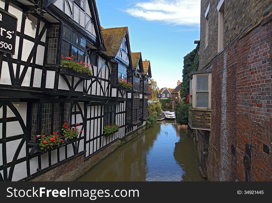These old Tudor houses lie on a river which is used to take people around the city/town of Canterbury, with the window boxes giving a hint of colour. These old Tudor houses lie on a river which is used to take people around the city/town of Canterbury, with the window boxes giving a hint of colour