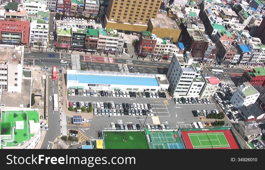 View of traffic on the streets of the city from a height of 100 m. Bright sunlight. The fast speed. View of traffic on the streets of the city from a height of 100 m. Bright sunlight. The fast speed