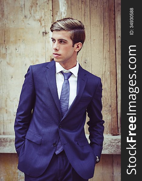 Attractive young businessman in urban background