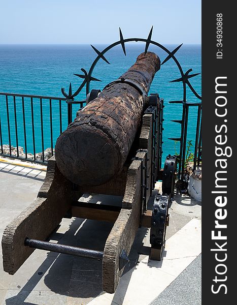 A rusty gun is at the end of the Balcony of Europe. The Balcon de Europa is a promenade built out onto a natural headland in the centre of Nerja. A rusty gun is at the end of the Balcony of Europe. The Balcon de Europa is a promenade built out onto a natural headland in the centre of Nerja.