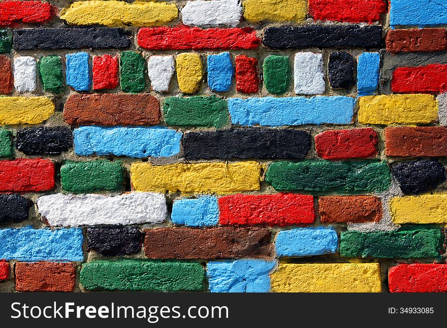 Wall of red, yellow, white, black, green and blue bricks. Wall of red, yellow, white, black, green and blue bricks