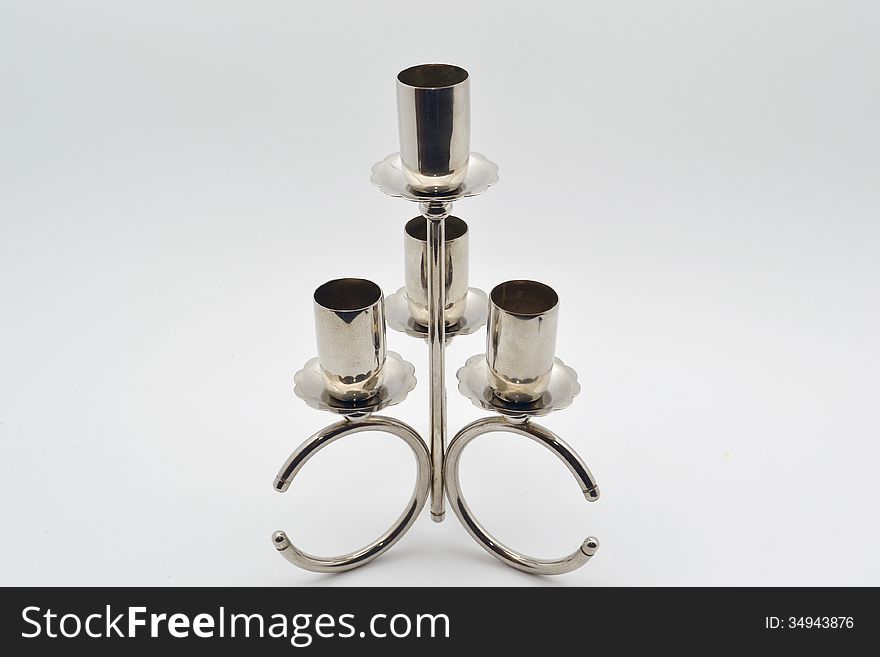 Old candlestick on a silver gray background degraded. Old candlestick on a silver gray background degraded