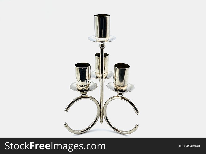 Old candlestick on a silver gray background degraded. Old candlestick on a silver gray background degraded
