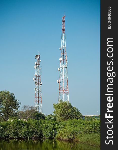 Microwave transmission tower with tree and pond. Microwave transmission tower with tree and pond.