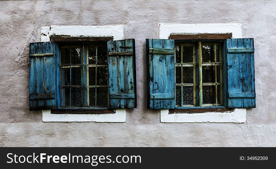 Two old windows with blue shutters. Two old windows with blue shutters.