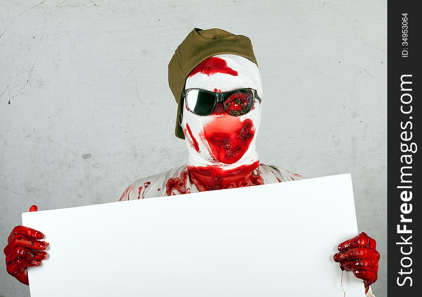 Scary Bloody Zombie Wearing A Cap And Glasses