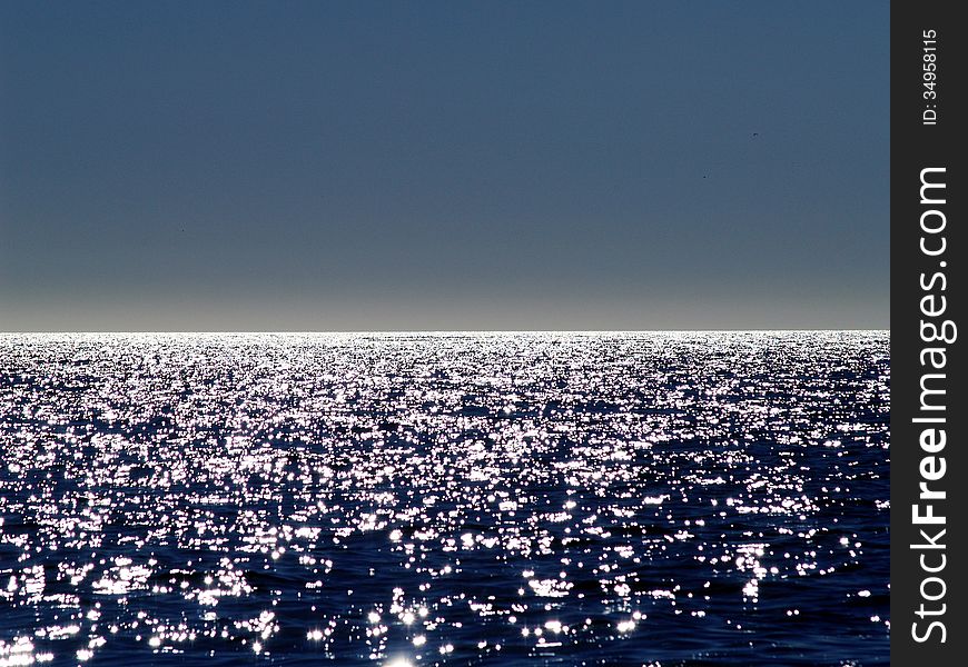 Patches of reflected sunlight on the sea. Patches of reflected sunlight on the sea.