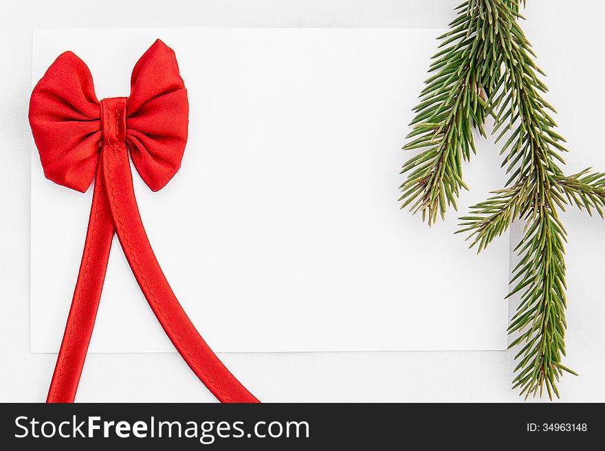 Christmas greeting card with a branch of tree and Christmas decorations