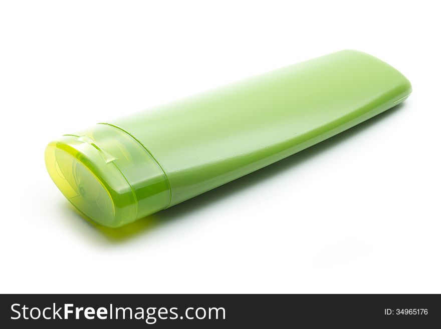 Green plastic cosmetic bottle isolated on white background. Green plastic cosmetic bottle isolated on white background