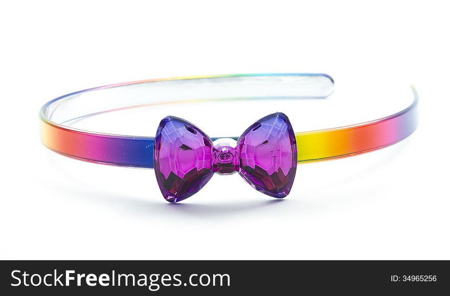 Plastic hairband with bow in rainbow color isolated on white background