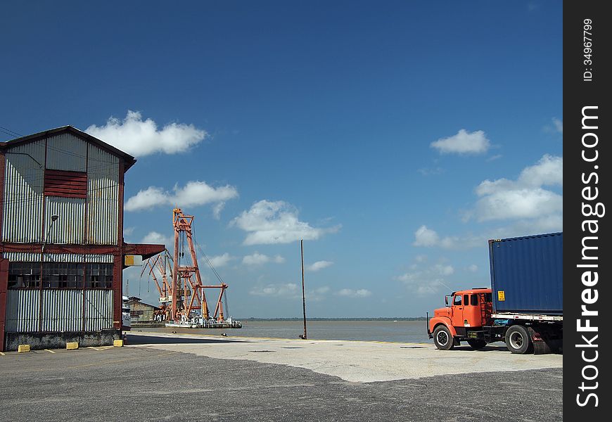 A loaded orange truck leaves Port in Belem (Amazonia), Brazil. It is one of the little ports of South America. A loaded orange truck leaves Port in Belem (Amazonia), Brazil. It is one of the little ports of South America.